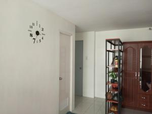 a room with a clock on the wall at San Jose Residencias / enchanted kingdom / nuvali / slex / sta. rosa / paseo in Santa Rosa