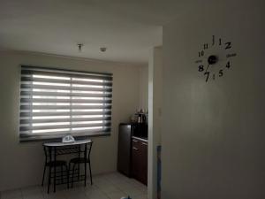 a kitchen with a window and a clock on the wall at San Jose Residencias / enchanted kingdom / nuvali / slex / sta. rosa / paseo in Santa Rosa