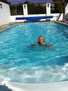 a young girl swimming in a swimming pool at Silverspring Hideaways in Constantine