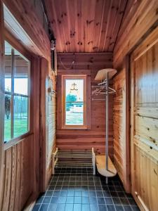 a room in a wooden cabin with a bench and a window at Peaceful log cabin in the country in Nurmijärvi