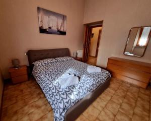 a bedroom with a bed and a mirror at Appartamento la Playa in Cagliari