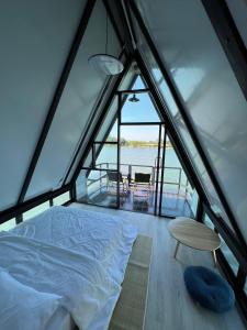 a bed and a table in a room with a window at ทุ่งดินดำ Farm Stay in Ban Kho Wang +65 photos