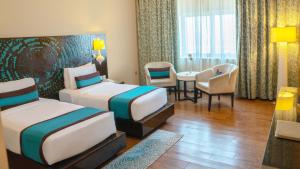 Postel nebo postele na pokoji v ubytování Signature Hotel Al Barsha