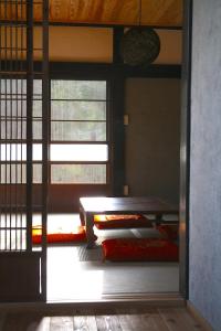 a room with two bunk beds and a window at Yokomura Eco-Lodge in Uenohara