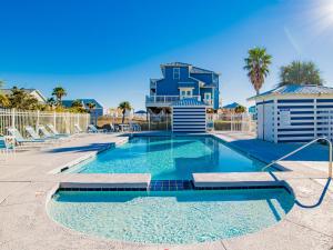 a swimming pool with a building in the background at Seahawk South B in Fort Morgan