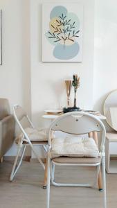 a white table and a chair in a room at Elio Del Ray in Bangkok