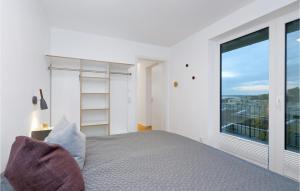 ein Schlafzimmer mit einem Bett und einem großen Fenster in der Unterkunft Beach Front Apartment in Lembruch