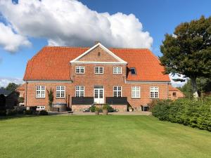 a large brick house with an orange roof at Store Sand in Vemb