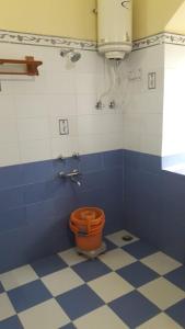 a blue and white bathroom with a toilet in it at Himalaya Heaven Homestay in Tharāli