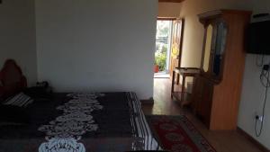 a bedroom with a bed and a television in a room at Himalaya Heaven Homestay in Tharāli +35 photos