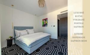 a bedroom with a bed and a poster on the wall at Hotel ZEMPLEN in Michalovce