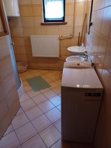 a small bathroom with a sink and a toilet at Domek u Piotra koło Szczyrku in Kalna +28 photos