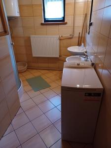 a small bathroom with a sink and a toilet at Domek u Piotra koło Szczyrku in Kalna