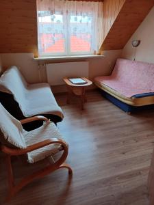 a room with two beds and a table at Domek u Piotra koło Szczyrku in Kalna