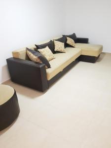 - un canapé dans le salon avec des oreillers dans l'établissement Apartmani Strahinic, à Leskovac