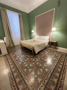 a bedroom with a bed and a rug at Bed in Spa in Palermo