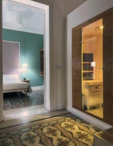 a room with a door leading to a bedroom at Bed in Spa in Palermo
