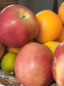 a pile of apples oranges and other fruits on a table at Sidharta Room in Villalba dels Arcs +14 photos