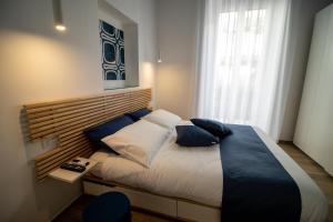 a bedroom with a large bed with blue pillows at La Cementina in Bari