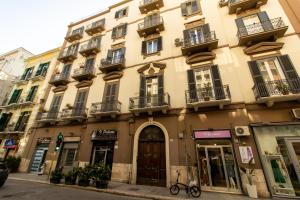 a building on a city street with a bike parked in front at La Cementina in Bari