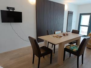 a dining room with a table and chairs at TINA Apartments in Černá v Pošumaví