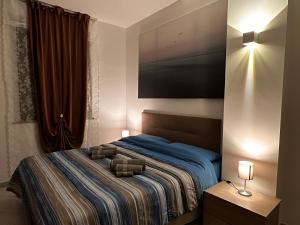 a bedroom with a bed with a television on the wall at Well Home Country in Montemarciano