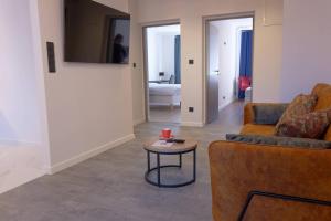 a living room with two couches and a table at Apartament e-Space in Rzeszów