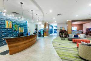 a lobby of a store with a counter and chairs at TownePlace Suites by Marriott Orlando at SeaWorld in Orlando