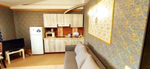 a living room with a couch and a kitchen at 1Центер квартира кондиціонер парковка WiFi in Ivano-Frankivsk