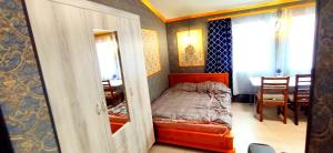 a small bedroom with a bed and a dining room at Be real центр квартира кондиціонер in Ivano-Frankivsʼk