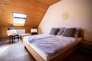 a bedroom with a bed in a wooden room at TINA Apartments in Černá v Pošumaví