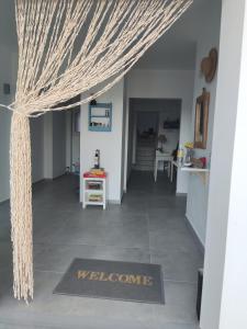 a welcome mat in the hallway of a house at Theros - Bahia in Elafonisos