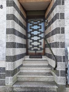 a set of stairs in a building with a door at Ferienwohnung am Rittershof Heusweiler in Heusweiler