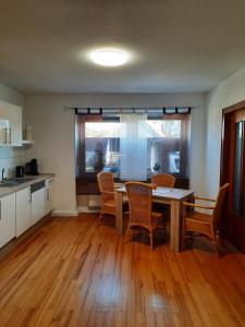 a kitchen and dining room with a table and chairs at Ferienwohnung am Rittershof Heusweiler in Heusweiler