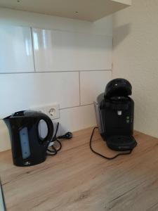 a blender and a toaster sitting on a counter at Ferienwohnung am Rittershof Heusweiler in Heusweiler