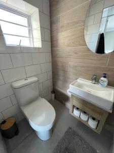 a bathroom with a toilet and a sink at Port St Francis - QuarterDeck in St Francis Bay +18 photos