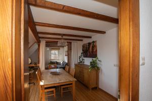 a living room with a table and a dining room at Pension Maria am Schlosspark in Gotha