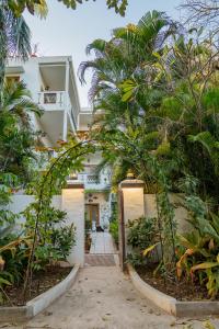 an archway leading to a white building with trees at Anchorage 42 in Chandīgarh +116 photos