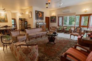 a living room with couches and chairs and a table at Anchorage 42 in Chandīgarh