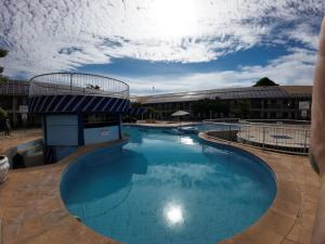 a large pool with blue water in front of a building at Hotel Pousada da Lapa in Bom Jesus da Lapa +31 photos