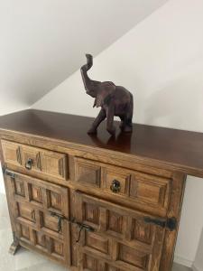 a statue of an elephant sitting on top of a dresser at ROYAL APARTMENTS in Lunca de Sus