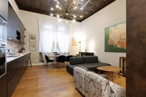 a living room with a couch and a table at La Chambre Milano in Milan
