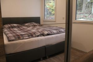 Ένα ή περισσότερα κρεβάτια σε δωμάτιο στο Ferienhaus Refugium