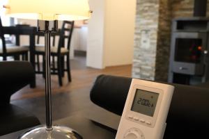 a remote control sitting on a table next to a lamp at Ferienhaus Refugium in Sessenbach