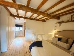 a bedroom with a bed and a wooden floor at Castle View by Peake’s Retreats in Tutbury