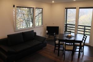 a living room with a couch and a table and chairs at Ferienhaus Refugium in Sessenbach