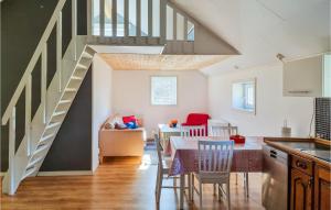 a kitchen with a dining room table and a staircase at 2 Bedroom Stunning Apartment In Skrhamn in Klövedal