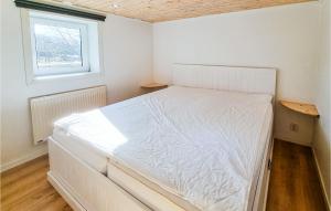 a white bed in a room with a window at 2 Bedroom Stunning Apartment In Skrhamn in Klövedal