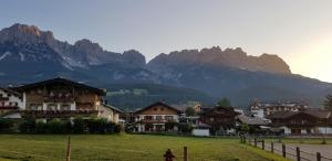 a village with houses and mountains in the background at Haus Hammerer in Ellmau