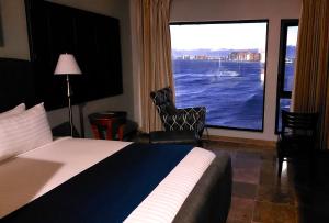 a hotel room with a bed and a large window at Peñasco del Sol Hotel in Puerto Peñasco